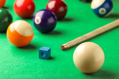 Photo of Classic white billiard ball on green table, closeup. Space for text