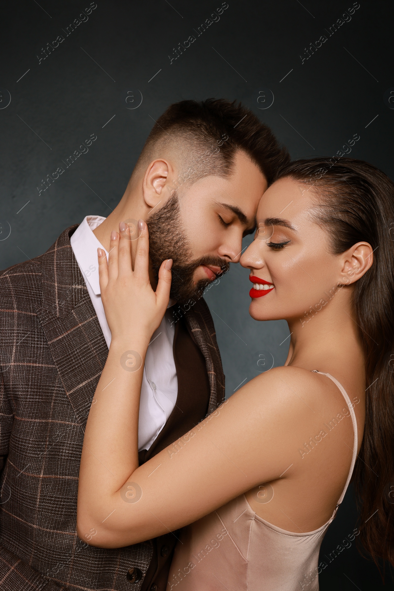 Photo of Handsome bearded man with sexy lady on grey background