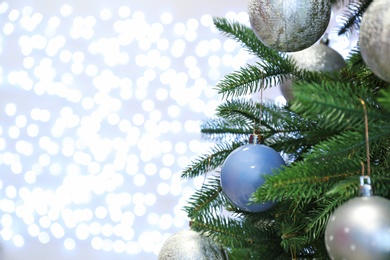 Christmas tree with festive decor against blurred fairy lights