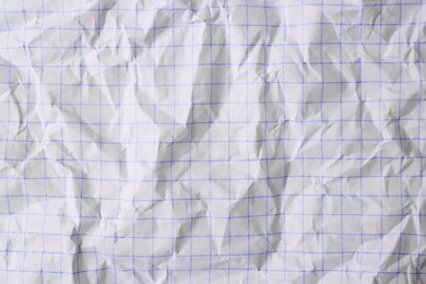 Photo of Sheet of crumpled checkered paper as background, top view