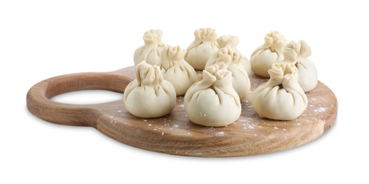 Photo of Wooden board with uncooked khinkali (dumplings) isolated on white. Georgian cuisine