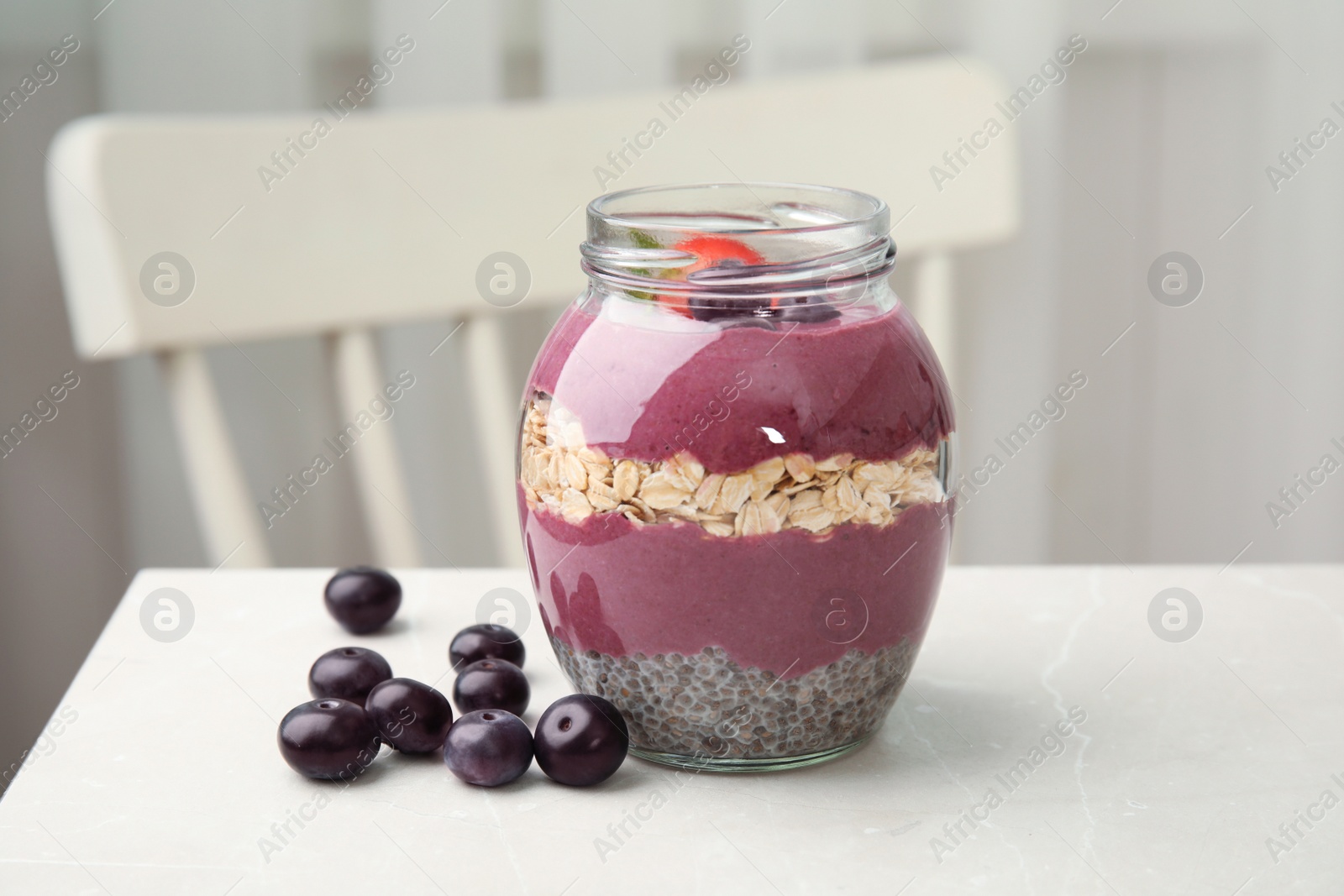 Photo of Jar of tasty acai smoothie on light table