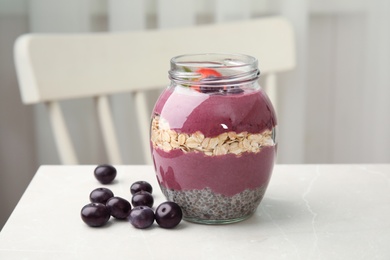 Photo of Jar of tasty acai smoothie on light table