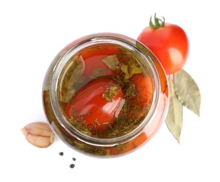 Photo of Pickled tomatoes in glass jar and products on white background, top view