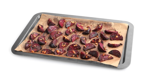 Baking tray with roasted beetroot slices on white background