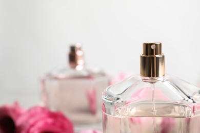 Photo of Bottle of perfume on blurred background, closeup. Space for text