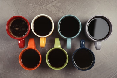 Photo of Flat lay composition with cups of coffee on gray background. Food photography