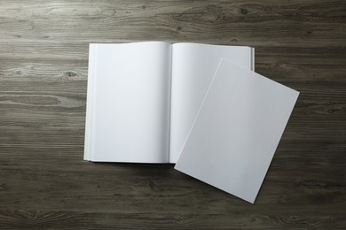 Sheet of paper and blank brochure on wooden table, flat lay. Mockup for design