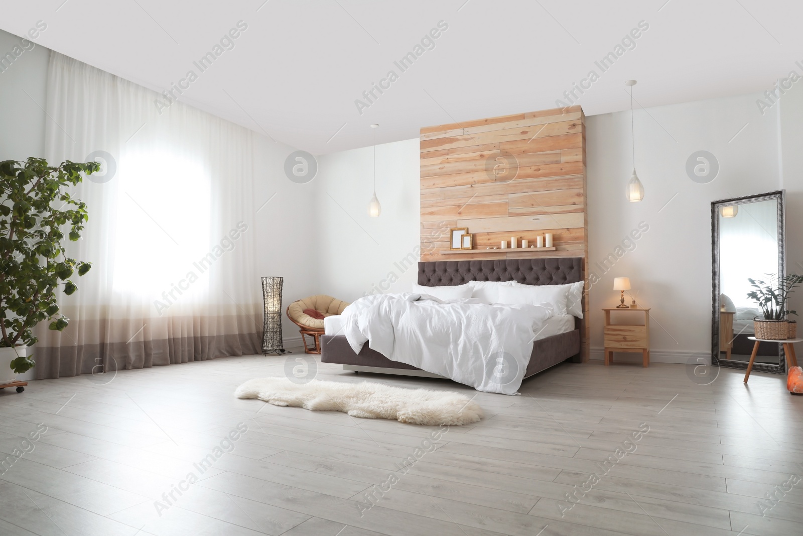 Photo of Large comfortable bed in stylish room. Modern interior design