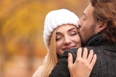 Photo of Young romantic couple hugging outdoors on autumn day