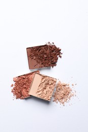 Different crushed eye shadows on white background, top view