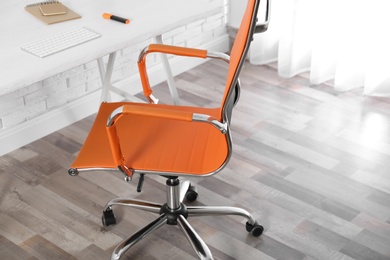 Comfortable workplace with office chair and wooden table