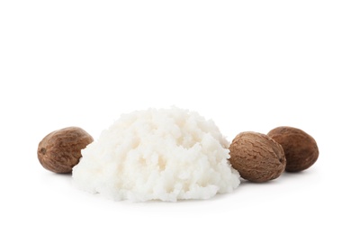 Pile of shea butter and nuts on white background