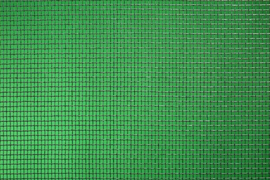 Photo of Closeup view of mosquito window screen on green background