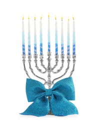 Photo of Hanukkah celebration. Menorah with colorful candles and bow isolated on white