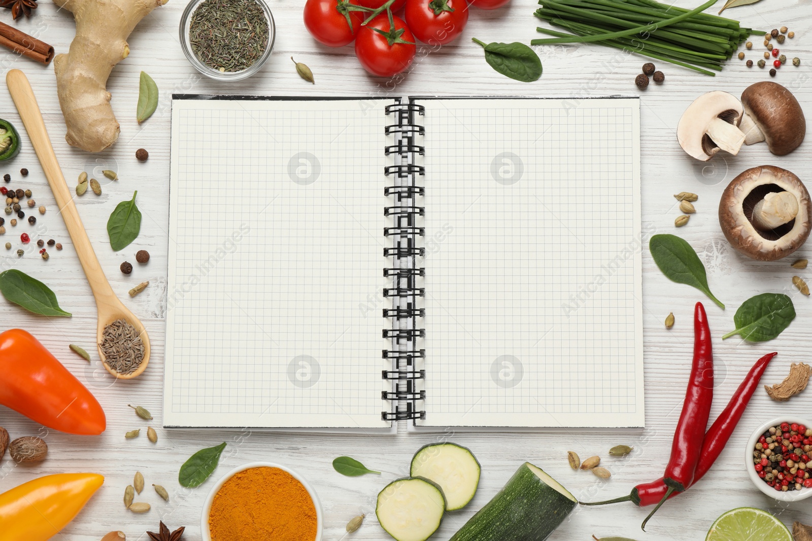 Photo of Open recipe book and different ingredients on white wooden table, flat lay. Space for text