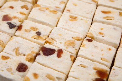 Photo of Pieces of delicious nougat as background, closeup