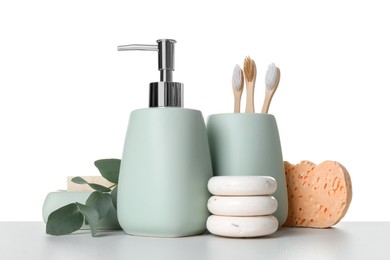 Bath accessories. Different personal care products and eucalyptus branch on table against white background