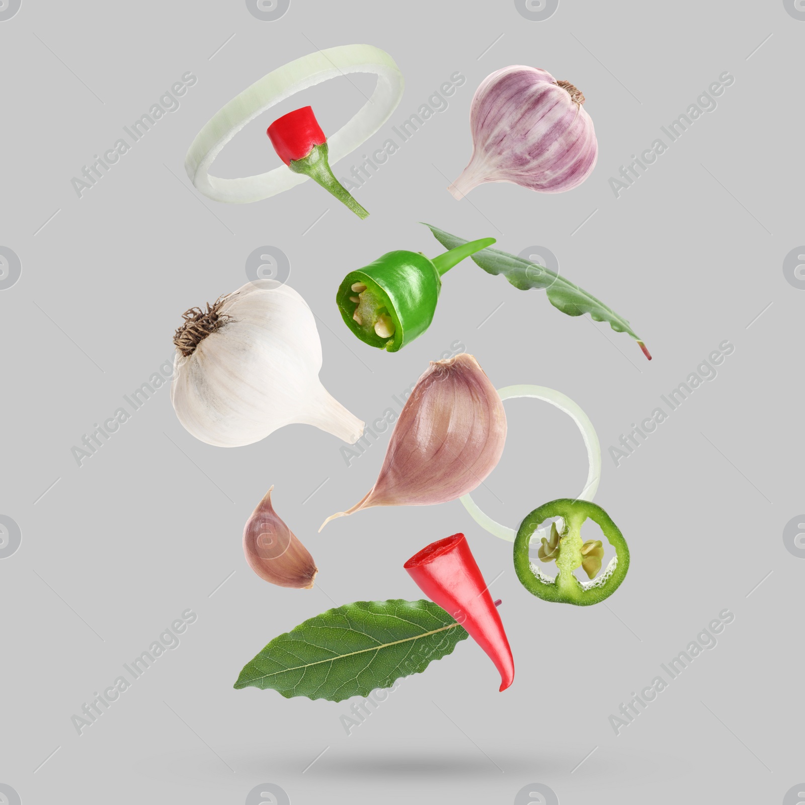 Image of Different spices falling on light grey background