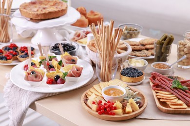 Photo of Dishes with different food on table indoors. Luxury brunch