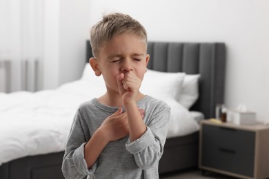 Photo of Sick boy coughing at home. Cold symptoms