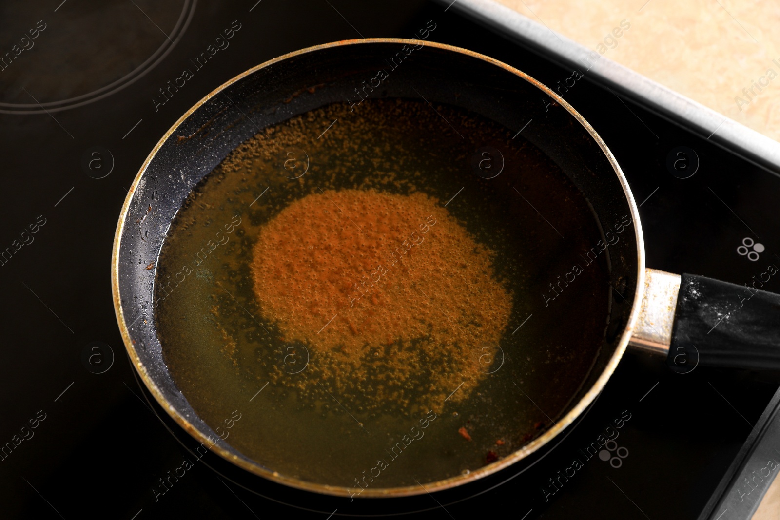 Photo of Frying pan with used cooking oil on stove