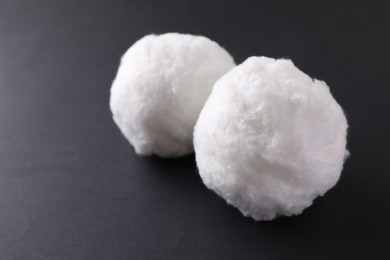 Photo of Balls of clean cotton wool on grey background, closeup. Space for text