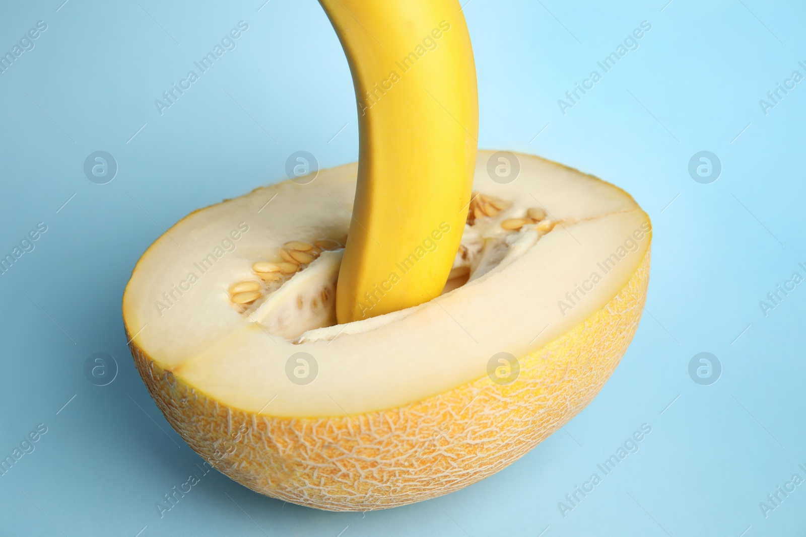 Photo of Fresh banana and melon on blue background. Sex concept