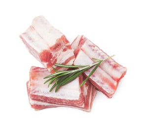 Photo of Cut raw pork ribs with rosemary isolated on white, top view