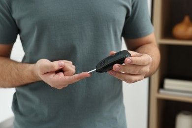 Diabetes test. Man checking blood sugar level with glucometer at home, closeup