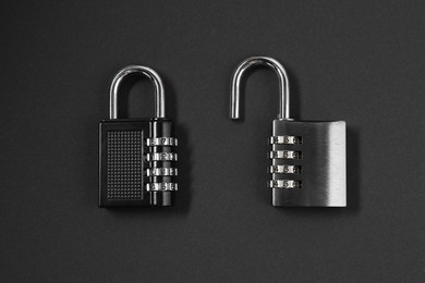Steel combination padlocks on black background, top view