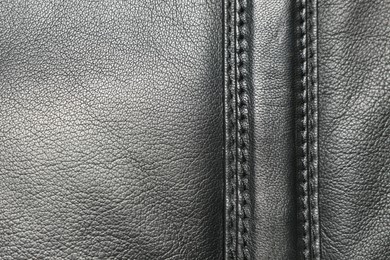 Photo of Black natural leather with seams as background, top view