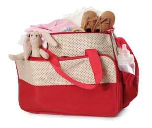 Photo of Maternity bag with child's clothes and accessories on white background