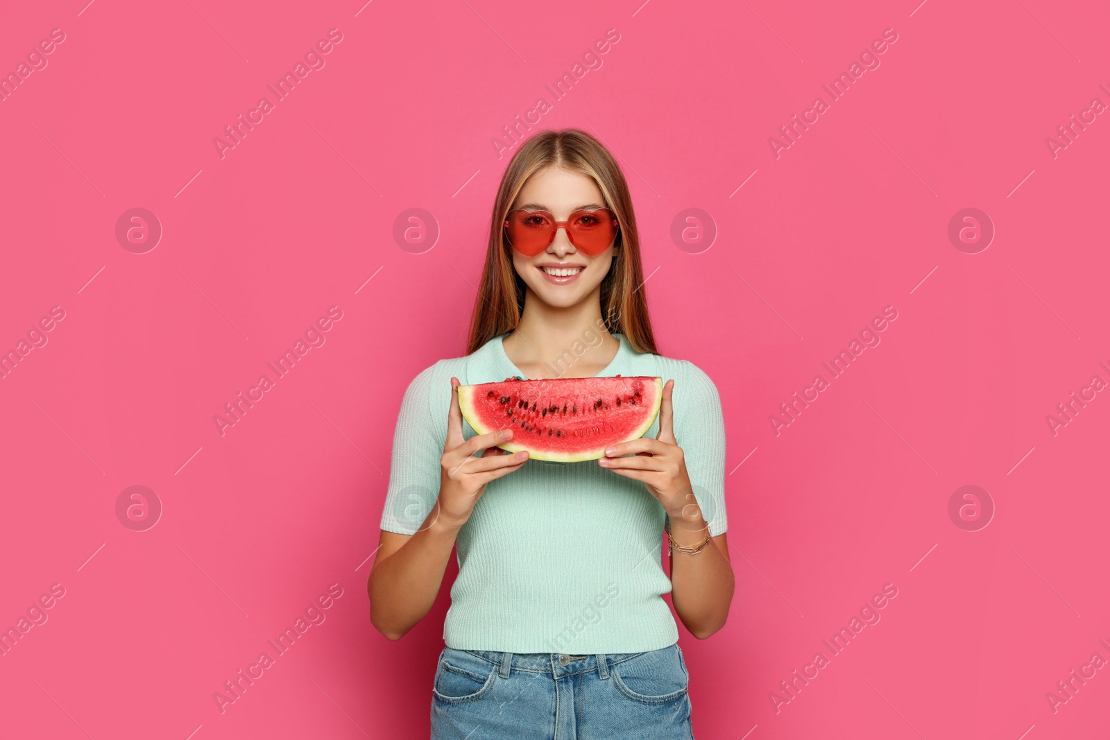 Photo of Beautiful girl with slice of watermelon on crimson background