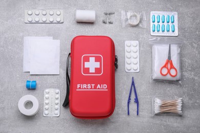 Photo of Flat lay composition with first aid kit on light gray background