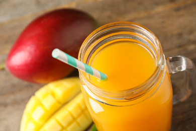 Fresh delicious mango drink on table, closeup