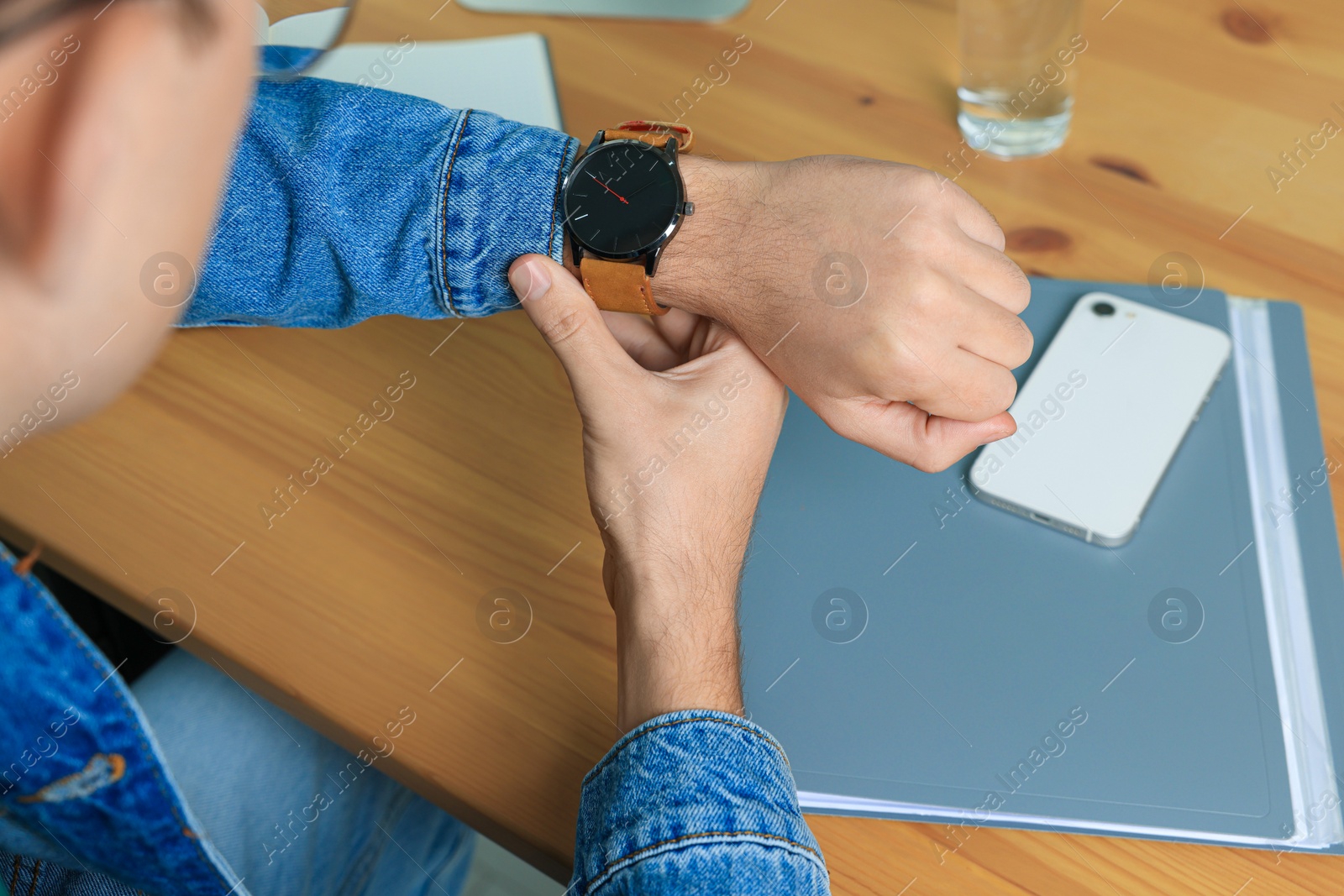 Photo of Man checking time in room, closeup. Being late