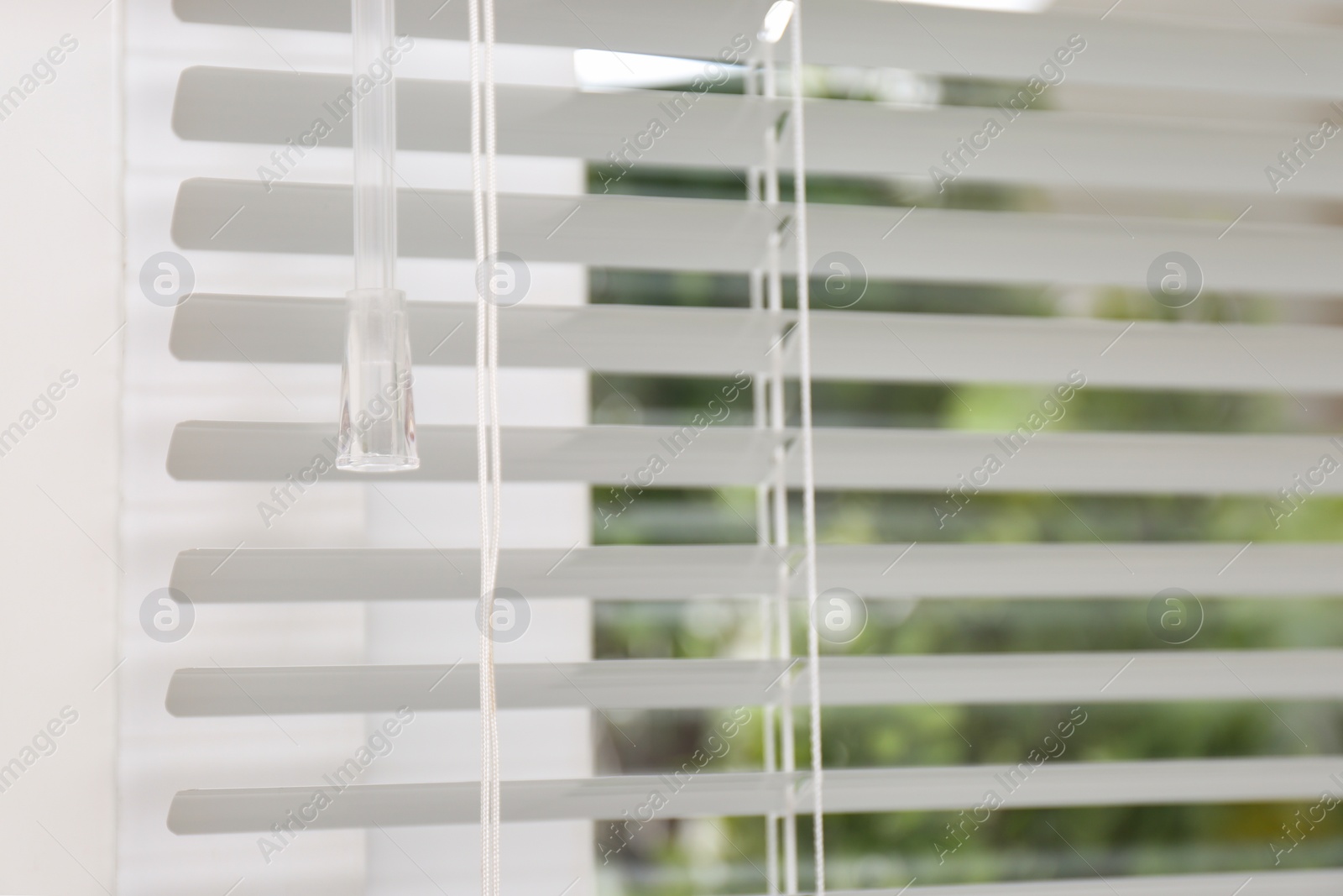 Photo of Open white horizontal window blinds, closeup view