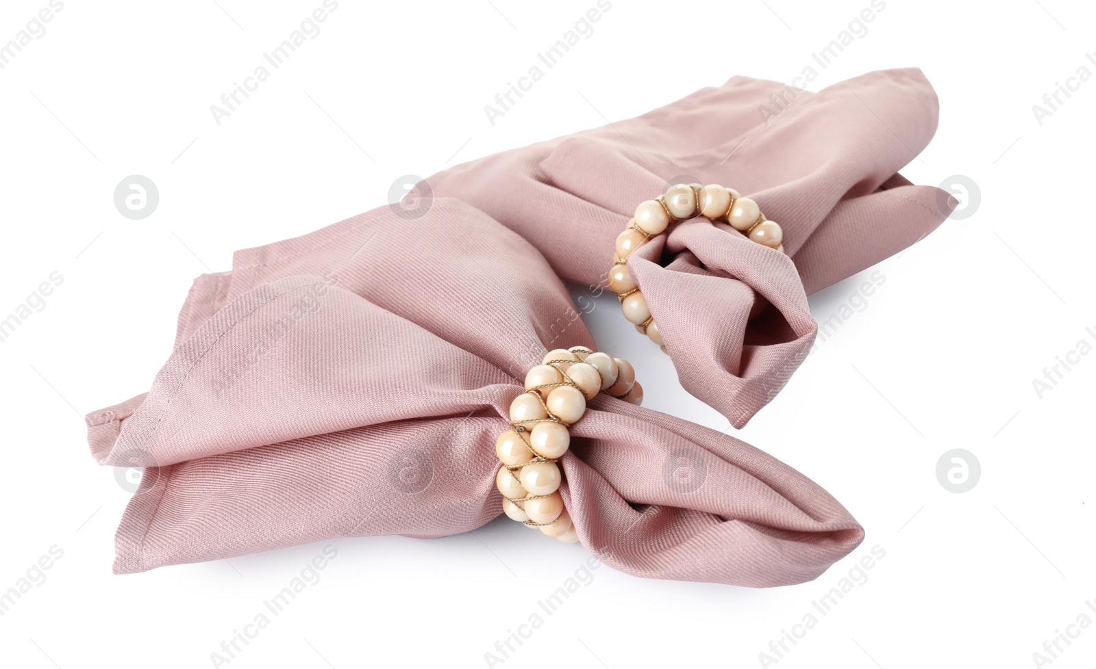 Photo of Fabric napkins with decorative rings for table setting on white background