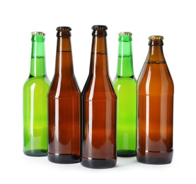 Photo of Bottles with different alcoholic drinks on white background