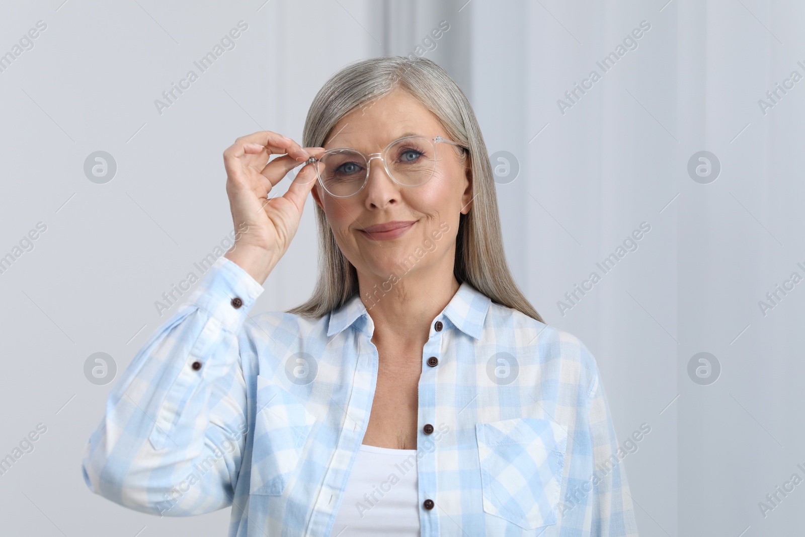 Photo of Portrait of beautiful senior woman in glasses indoors