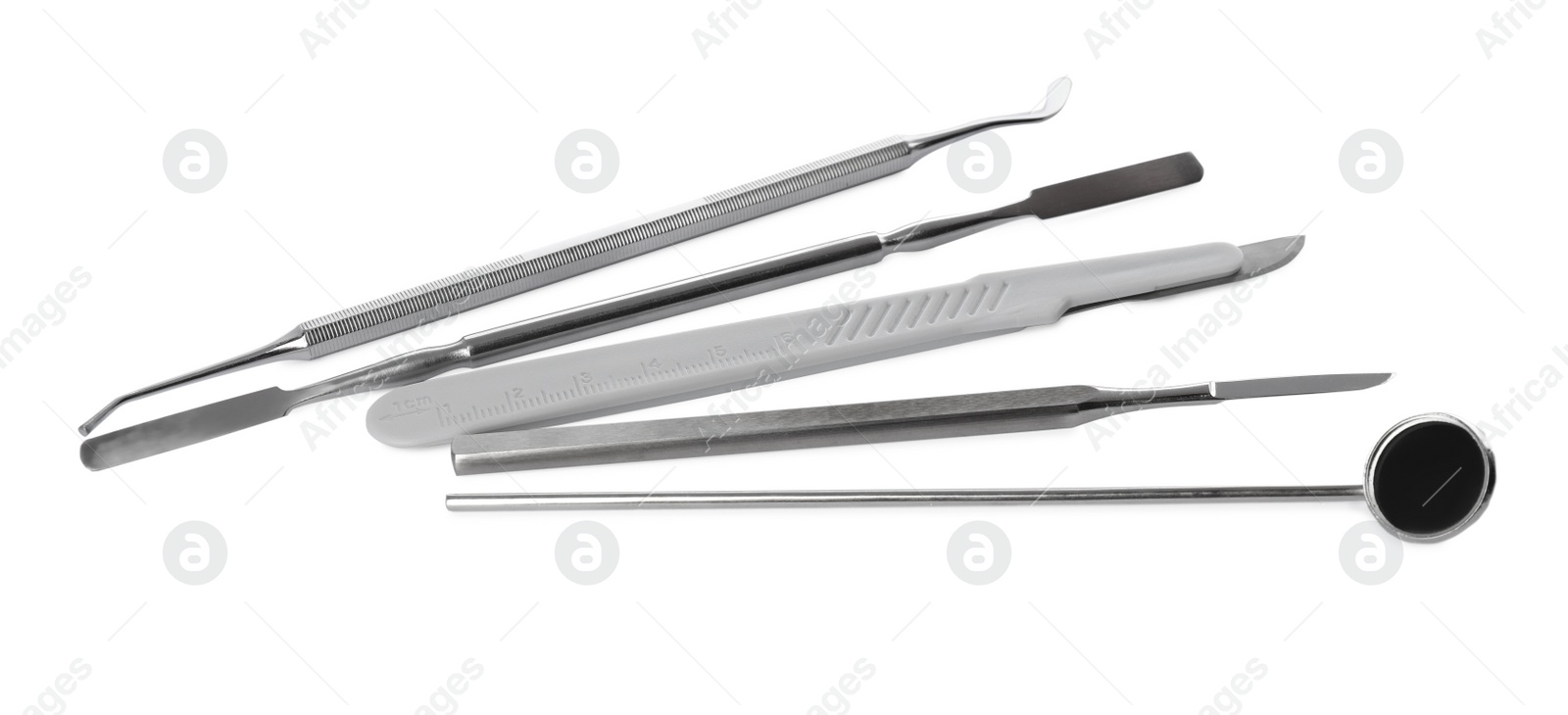 Photo of Set of different dentist's tools on white background