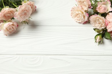 Happy Mother's Day. Beautiful flowers on white wooden table, flat lay. Space for text