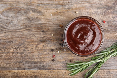 Photo of Flat lay composition with barbecue sauce on wooden background. Space for text