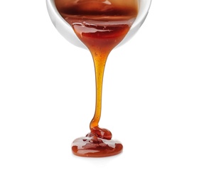 Pouring caramel sauce onto white background