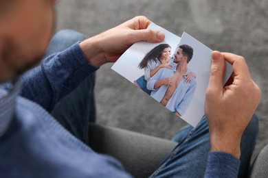 Photo of Man ripping photo on sofa indoors, closeup. Divorce concept