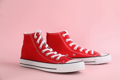 Pair of stylish sneakers on pink background