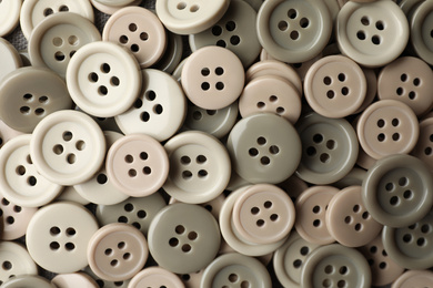 Many plastic sewing buttons as background, closeup