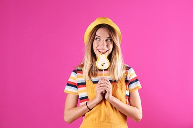 Photo of Young pretty woman with candy on colorful background