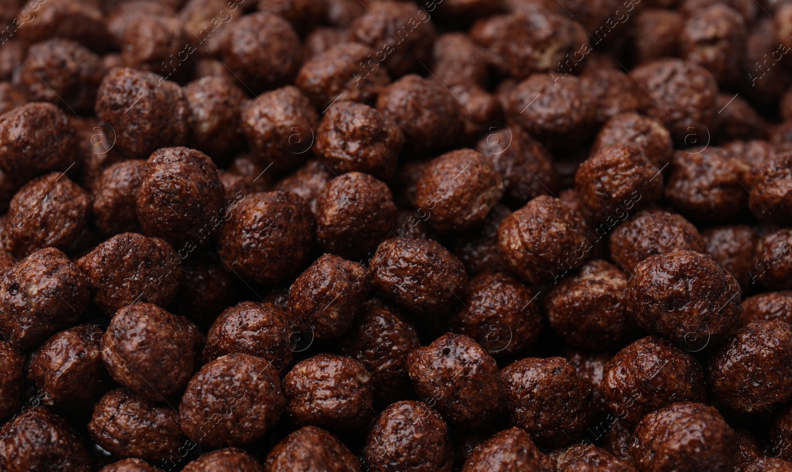 Photo of Tasty chocolate cereal balls as background, closeup